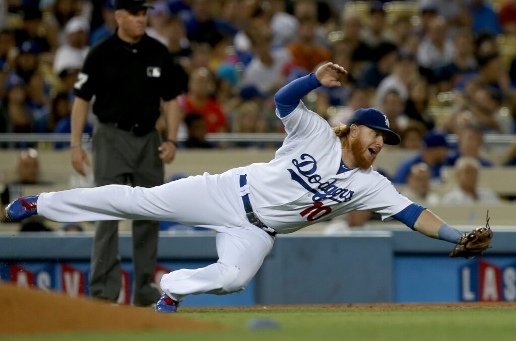 LOS ANGELES, CALIF. - AUG. 21, 2014. Dodgers third baseman Justin Turner dives for a ball hit shraply off the bat of Padres left fielder Abraham Almonte in the seventh inning on Thursday, Aug. 21, 2014, at Dodger Stadium in Los Angeles. (Luis Sinco/Los Angeles Times)